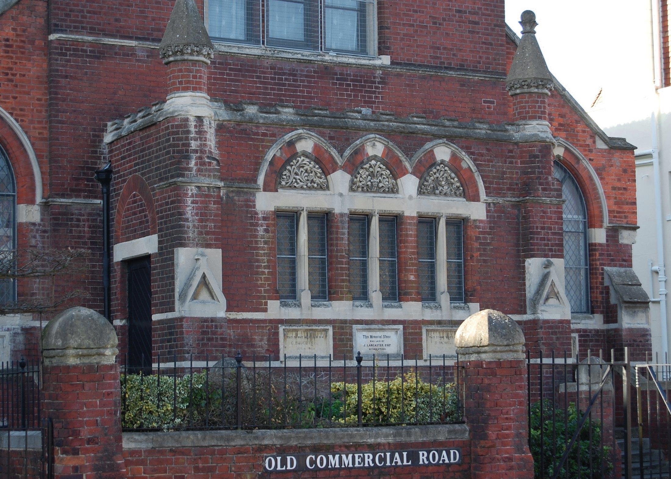 The carved stone arches and leaded windows on the front of the masjid
