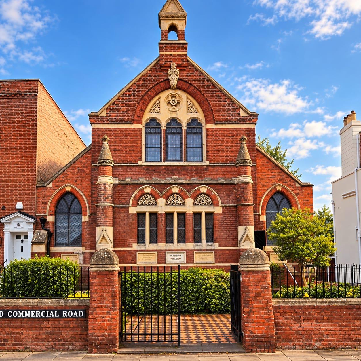 The red brick gable of the Victorian chapel on Old Commercial Road under a blue sky